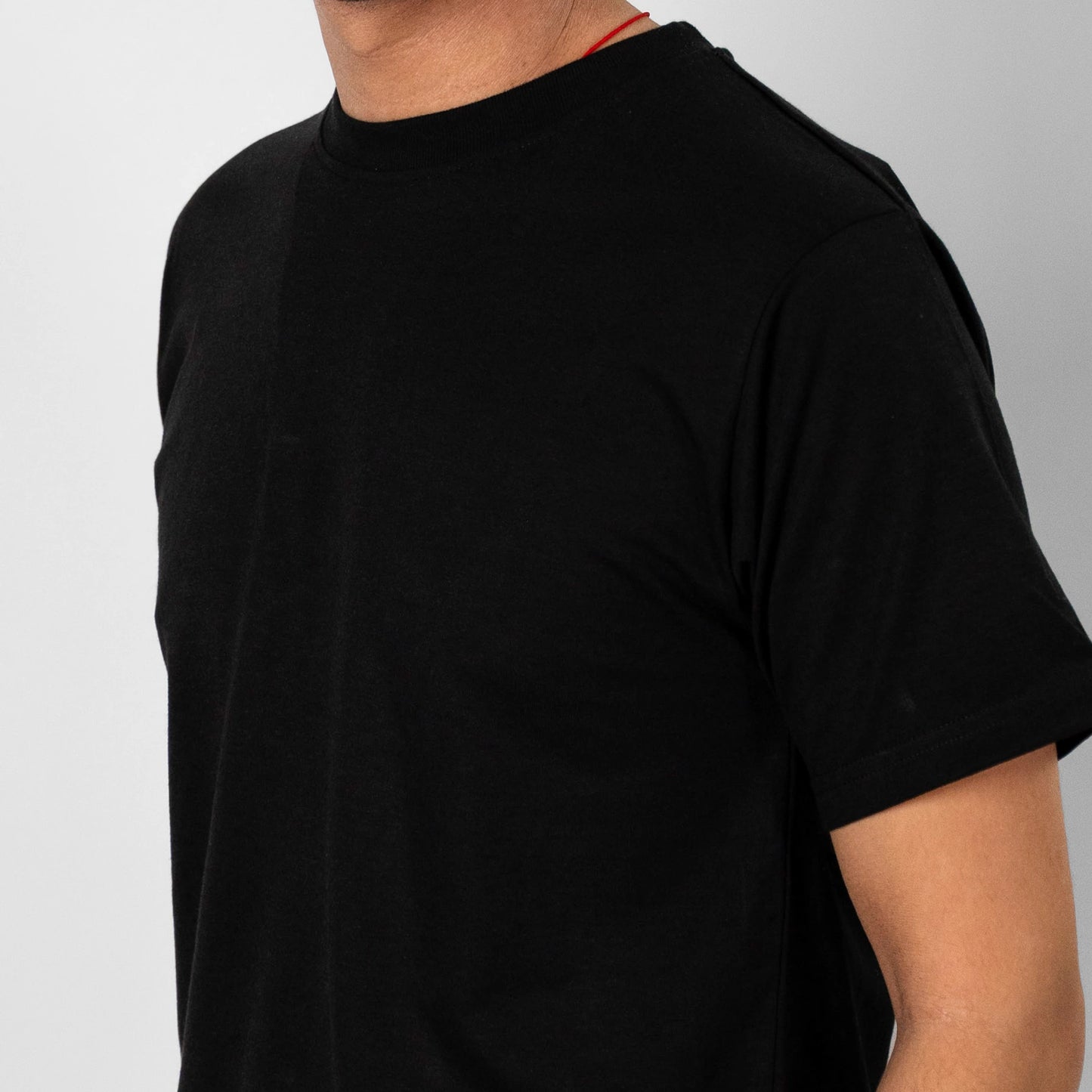 The Zenboo Original T-Shirt in black, a cropped close-up. Sustainable, soft, breathable bamboo fabric.